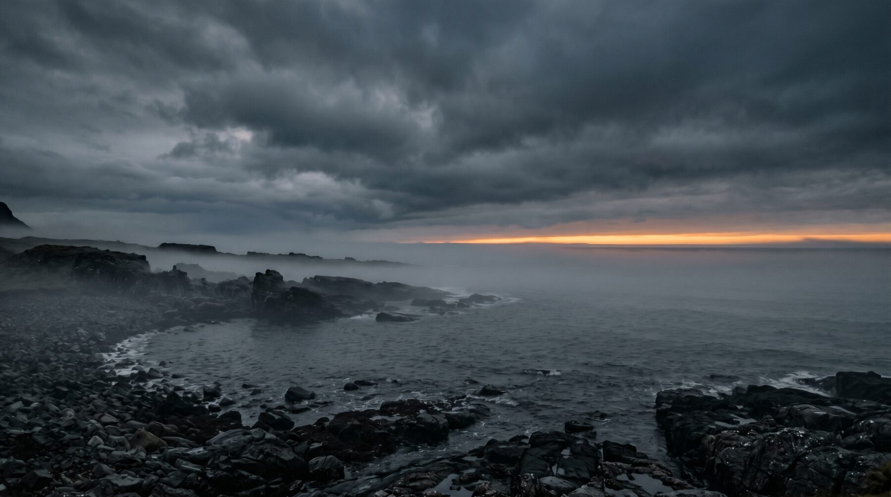 Nordic coastline at dawn with amber horizon line